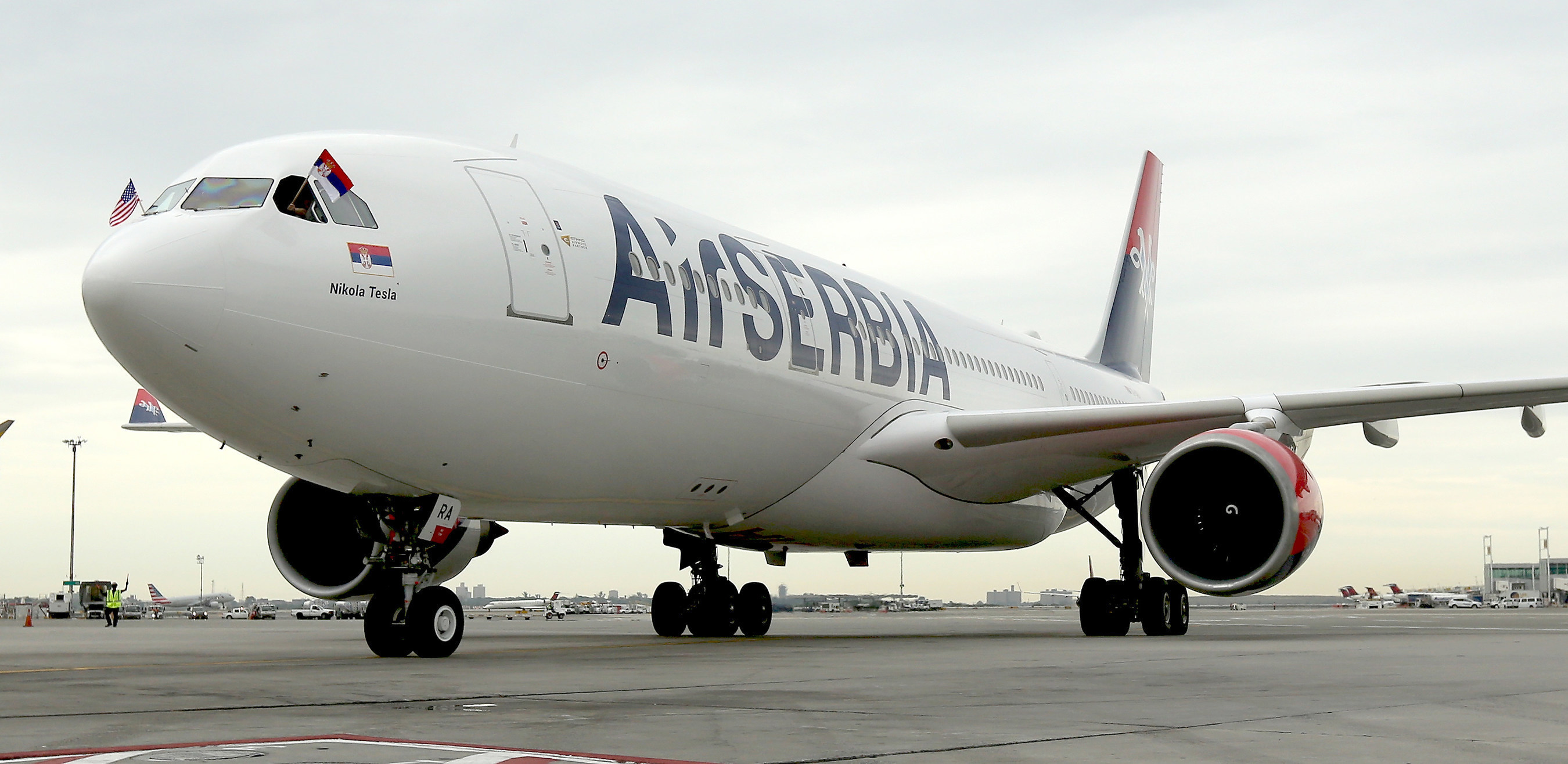 With Serbian and American flags flying high, Air Serbia's first flight JU 500 from Belgrade to New York taxis to a stop at JFK International Airport.