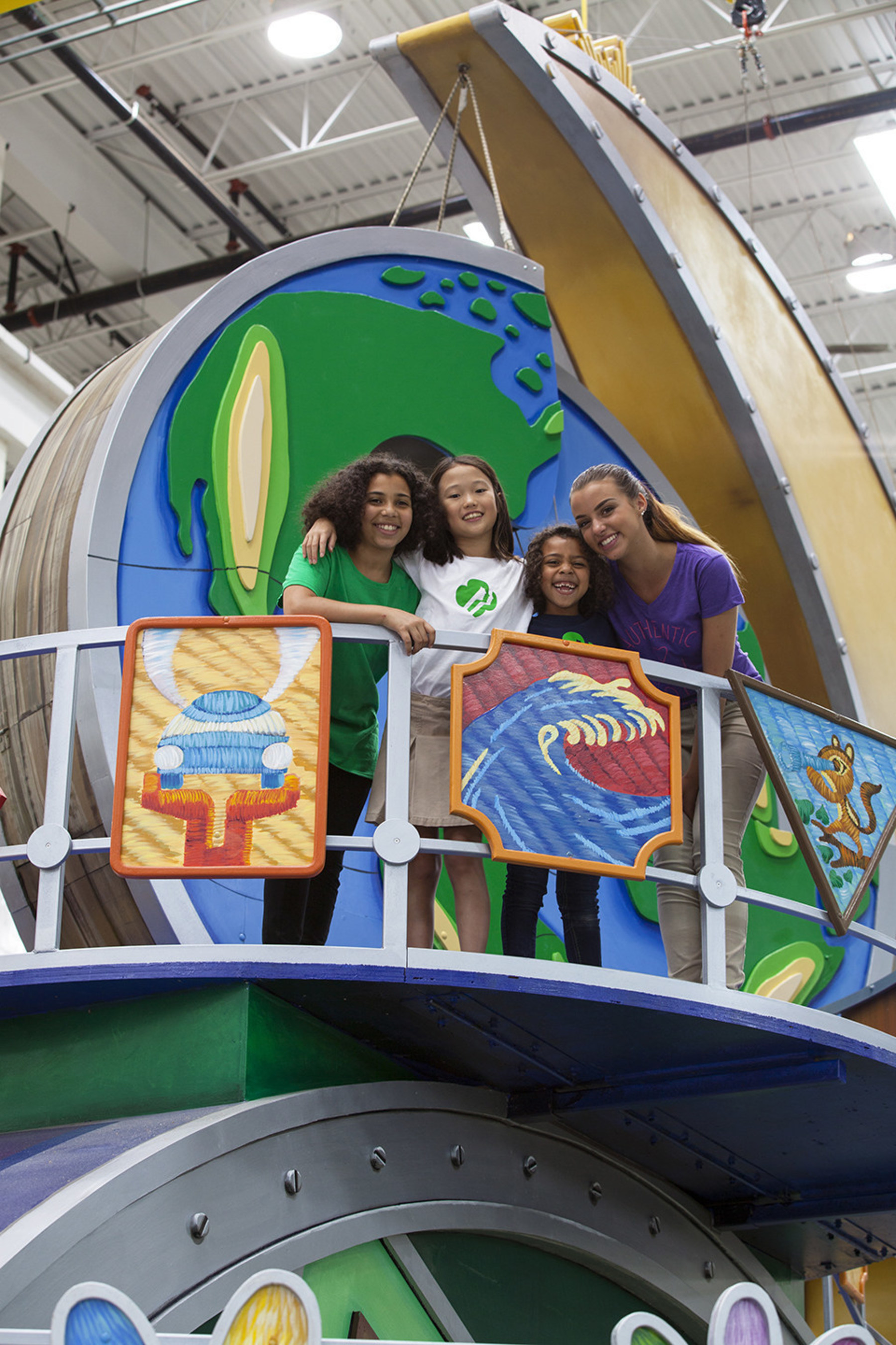 In addition to the giant 3-D puzzle pieces of the globe, the float features two dozen Girl Scout badges, representing everything from STEM and the outdoors to financial literacy and entrepreneurship, a friendship circle, and a Gold Award symbol that marks this year's centennial.