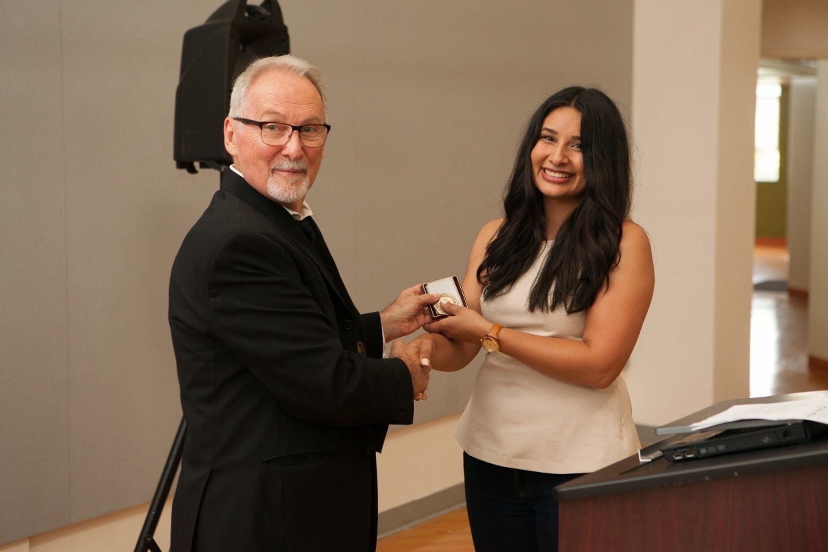 Harpreet Basi, of Sanger, California, receives the prestigious Alpha Rho Chi Medal from Len Zegarski, Chair, Undergraduate Architecture for NewSchool of Architecture & Design in San Diego. Since 1931, the Alpha Rho Chi Medal recognizes graduating architecture students for their leadership and service and for what they have to offer to the future of the profession with the Alpha Rho Chi Medal.