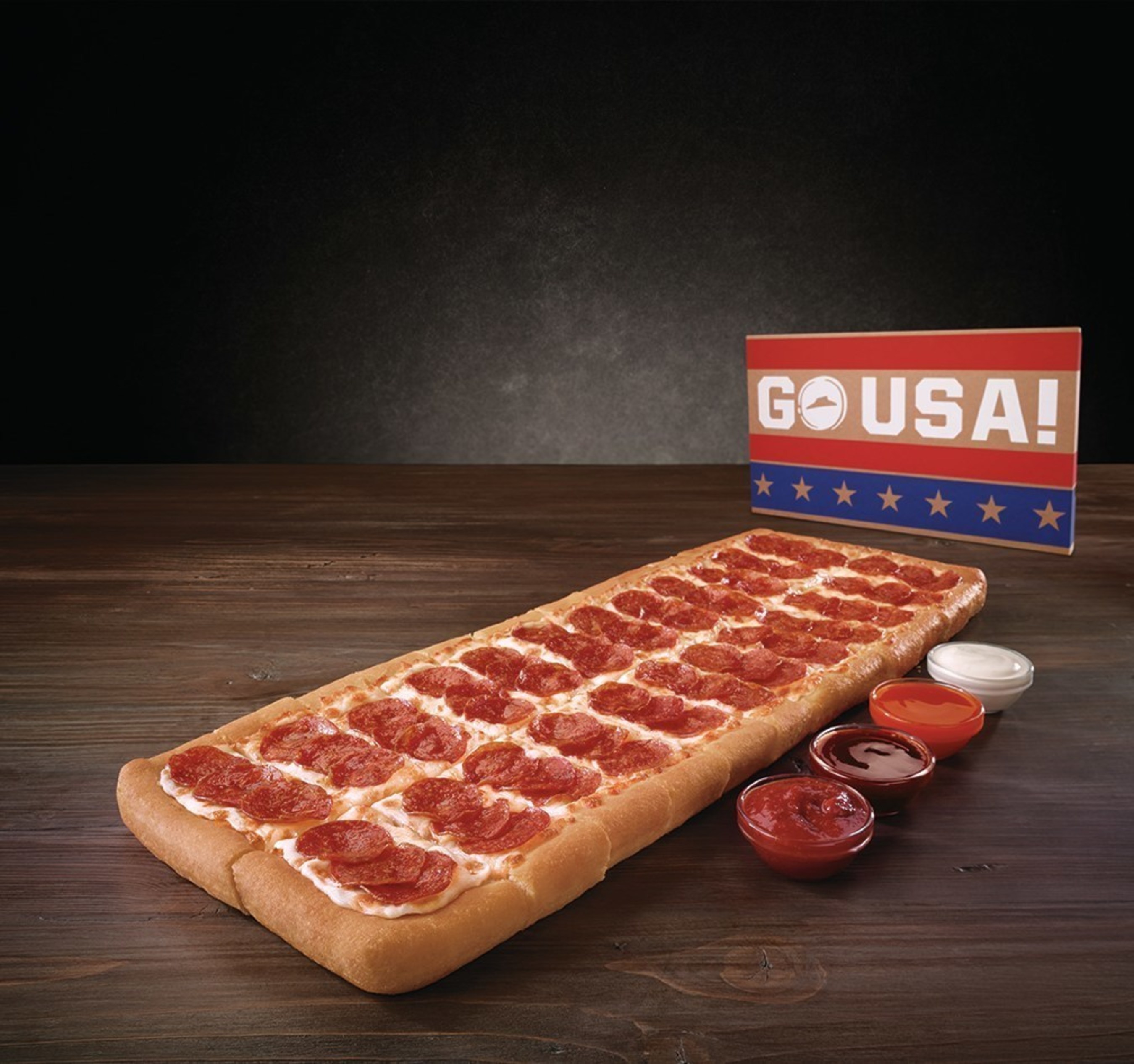 Pizza Hut will please crowds this summer with the Big Flavor Dipper Pizza, a pizza that is nearly two-feet long and features U.S.-inspired sauces - all served in a patriotic box - for only $12.99.