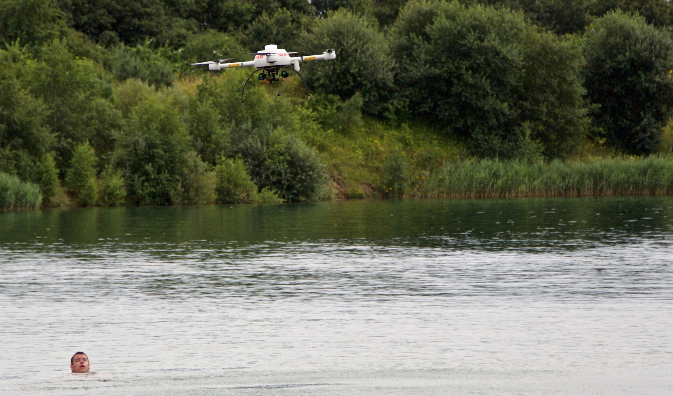 A microdrones md4-1000 UAS drops a compact rescue device called RESTUBE; the swimmer in this demonstration was able to grab onto the RESTUBE and float until they could be brought back to safety.