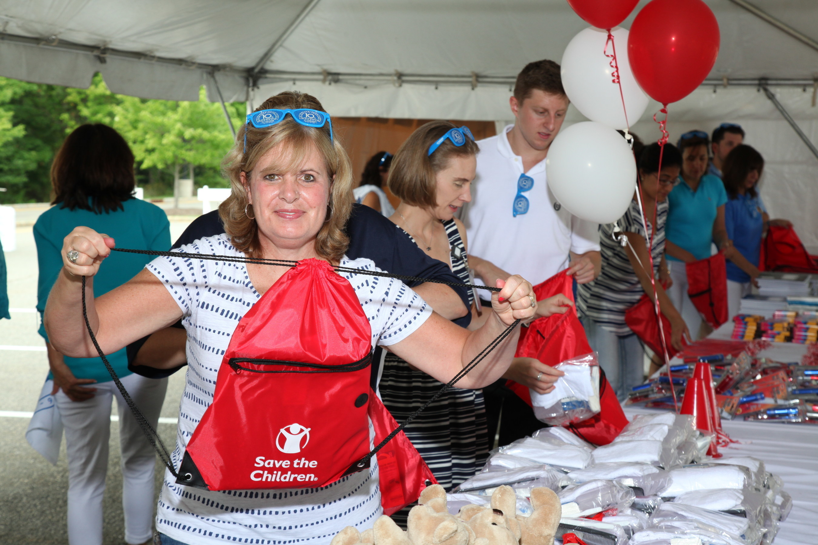 Wyndham Worldwide associates create emergency preparedness kits as part of the announcement of its global partnership with Save the Children.
