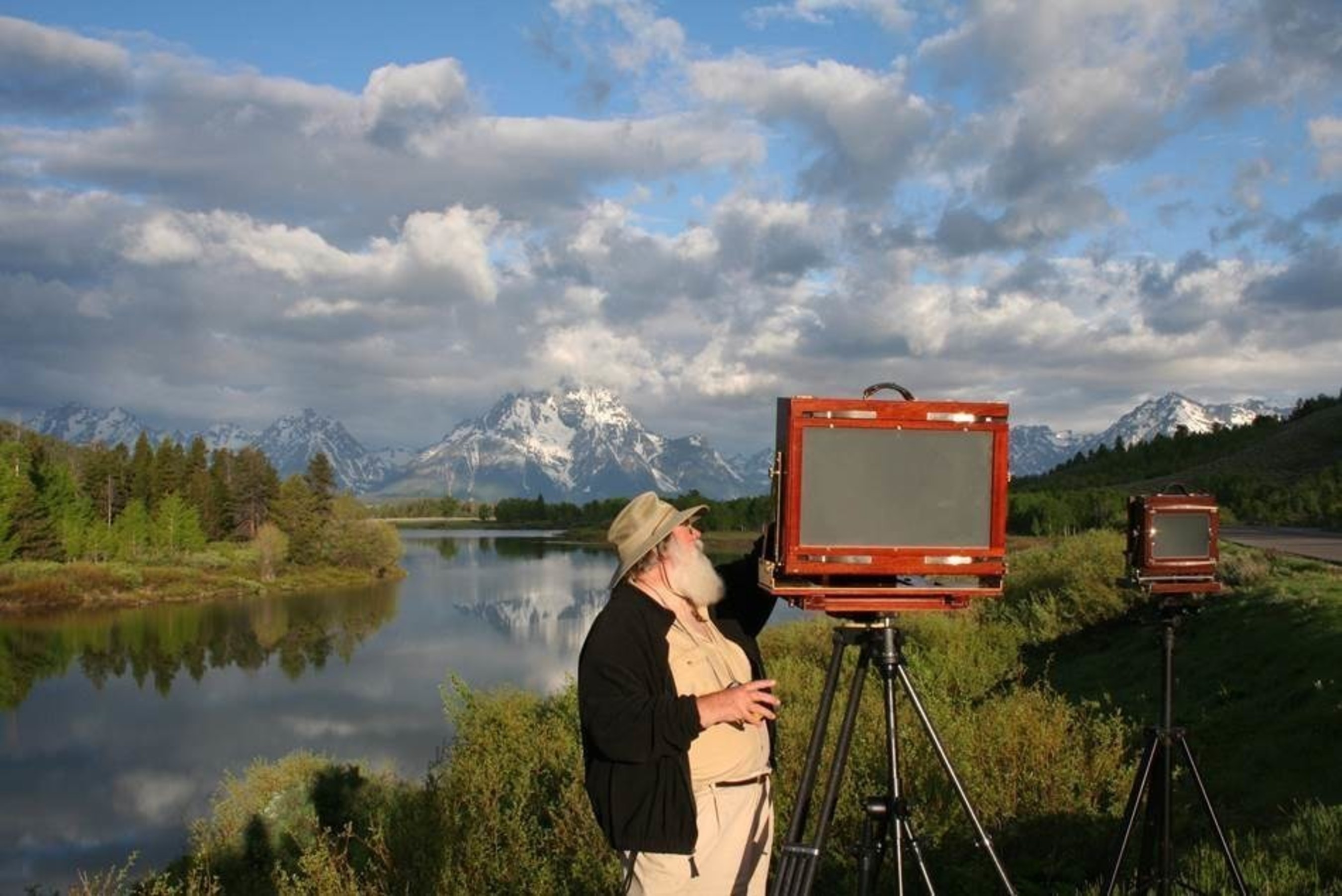 Legendary landscape photographer Clyde Butcher sets up his cameras -- his 5"x7" Deardorff is dwarfed by his massive 12"x20" (40lb) Wisner to capture a photo series at iconic Oxbow Bend, located in Grand Tetons National Park. Butcher has spent 50 years photographing 33 U.S. National Parks to create a timeless collection highlighted in his new book "Celebrating America's National Parks."