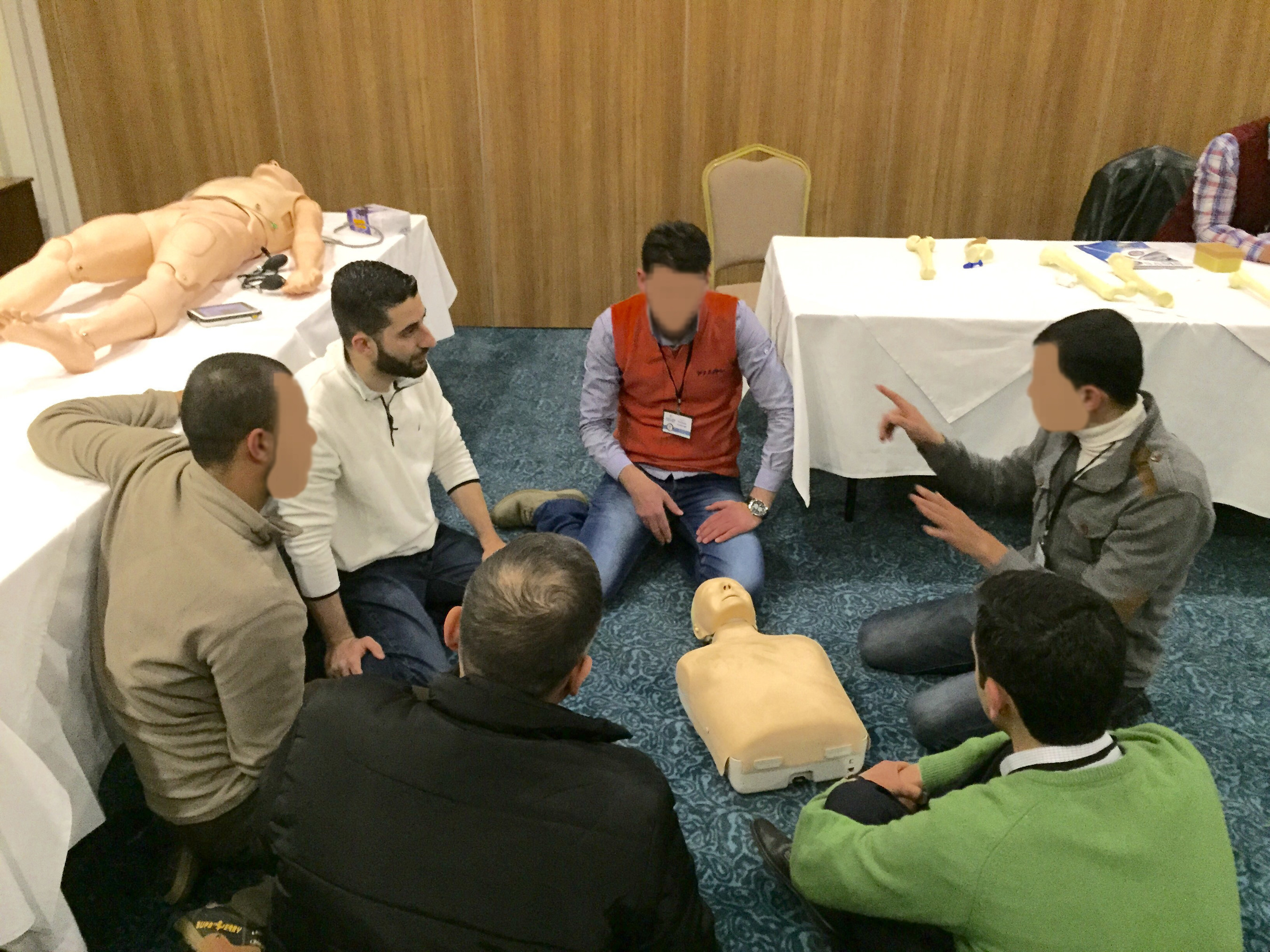 Dr. Wael Hakmeh teaches a trauma course to Syrian healthcare workers in Turkey. Faces are concealed to protect their identities.