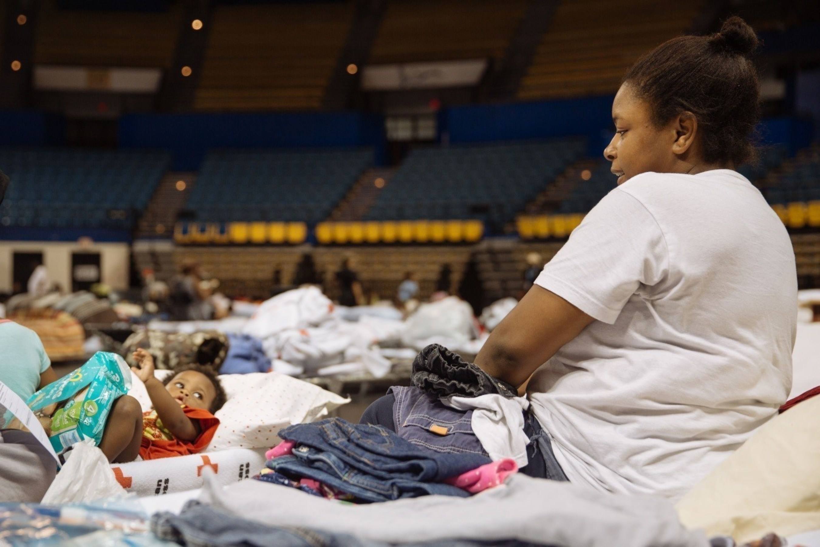 Tenisha Longmire keeps a watchful eye over her 2 year old, Derrick, in a Red Cross shelter in Baton Rouge. Red Cross Photo by Nicholas Small
