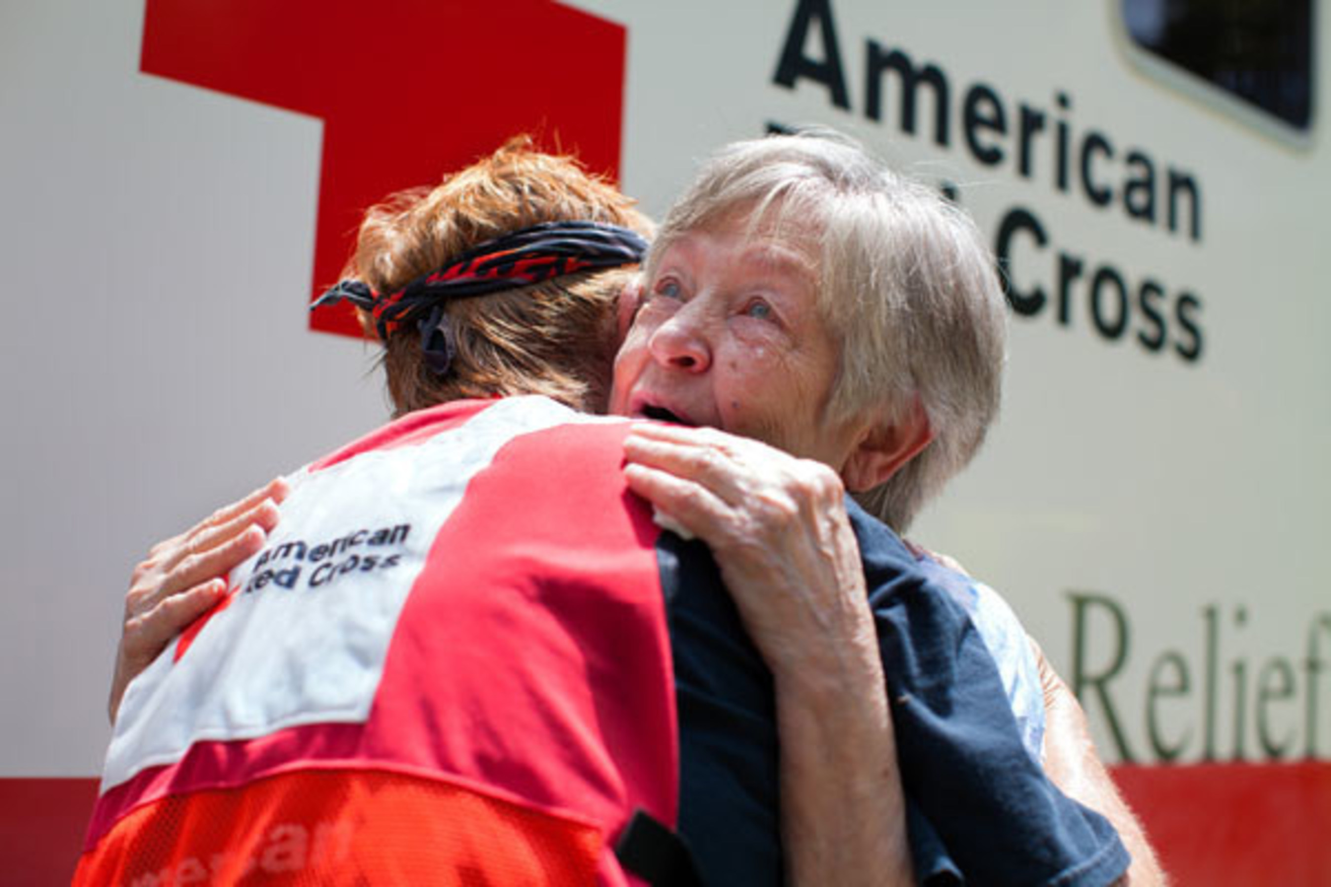 Tears fill Fonda Buckley's eyes as she gets a hug from Red Cross volunteer Cora Lee. Buckley's home was flooded in Denham Springs, Louisiana. Red Cross photo by Marko Kokic