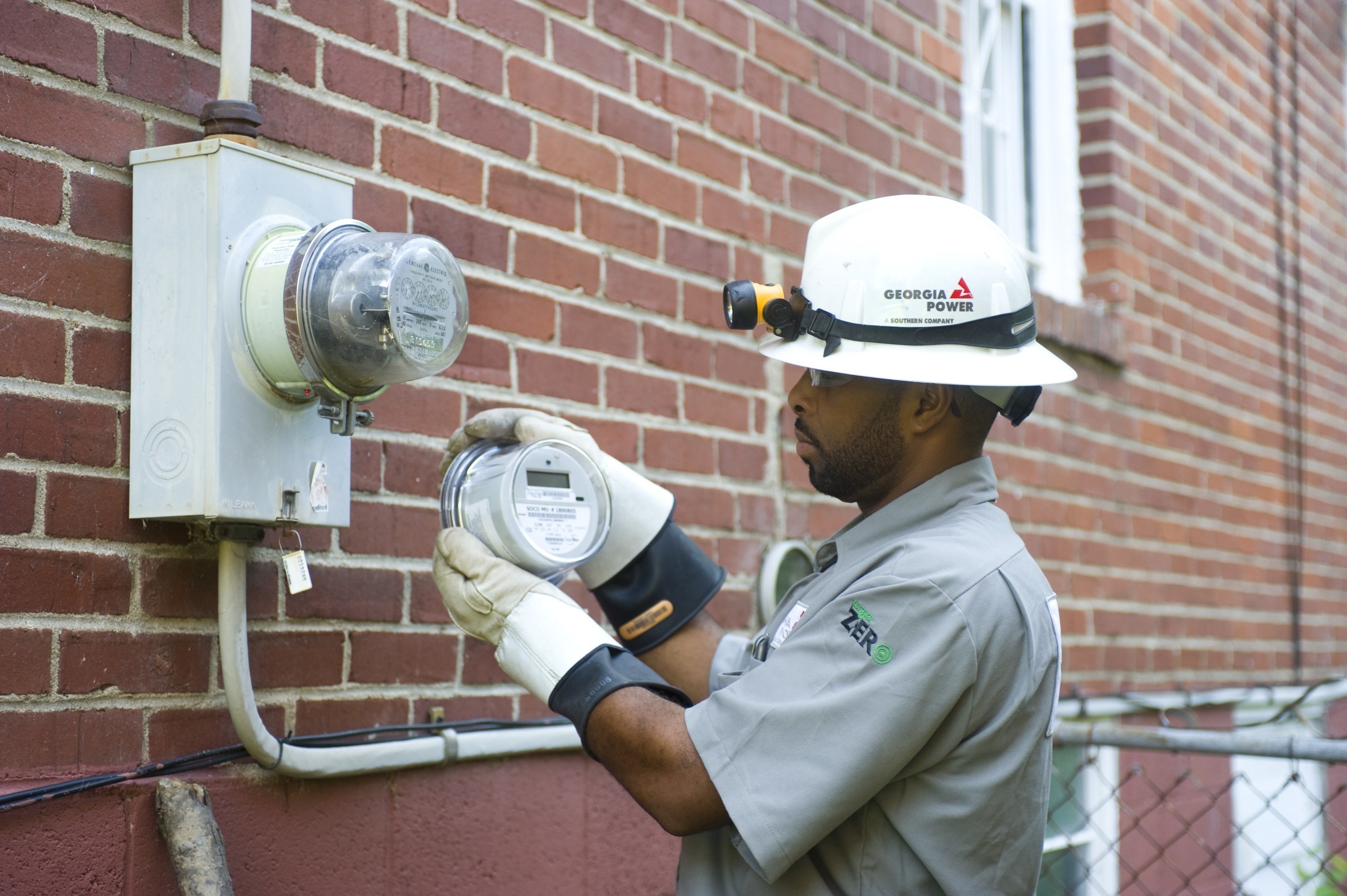 A Georgia Power employee replaces a mechanical meter with a digital "smart" meter in 2009. The meters are a part of the company's smart grid, which is reducing the frequency and duration of power outages.