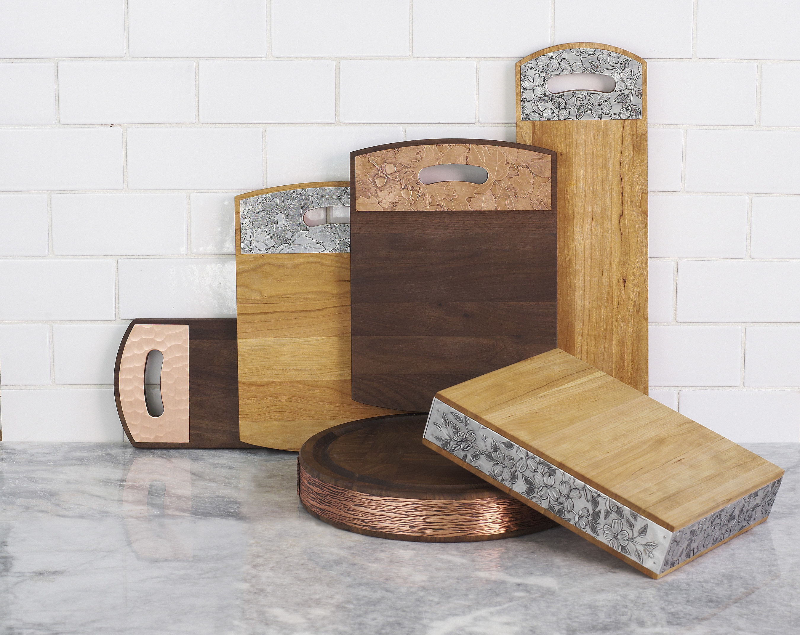 Wendell August and Warther Cutlery present a new collection of cutting boards combining meticulous woodworking with hand hammered metal. The result is a board that is both beautiful and functional.
