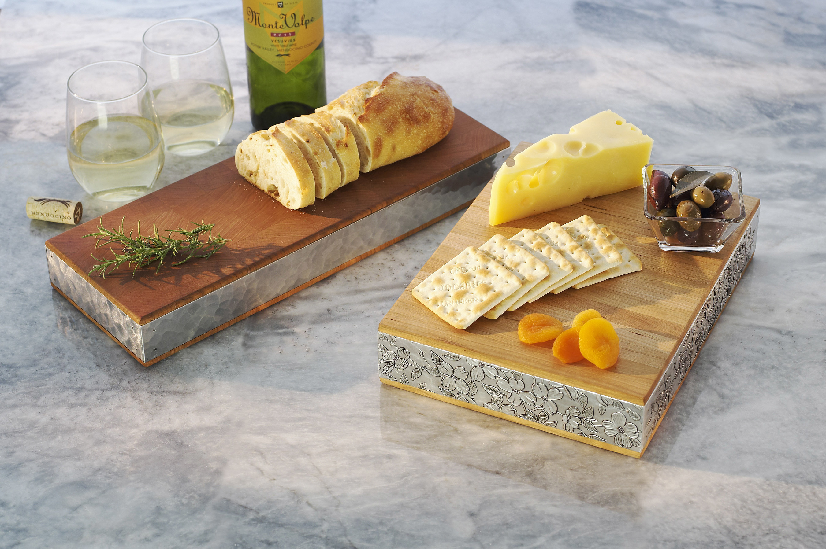 Iconic Wendell August metal designs adorn quality Warther cutting and serving boards to create functional pieces of art for everyday use in the kitchen.