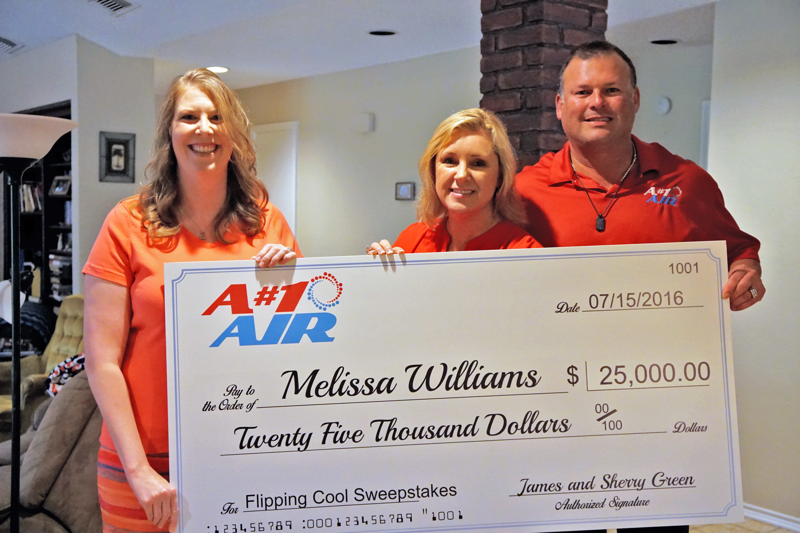 A#1 Air owners Sherry and James Green present Melissa Williams, winner of the A#1 Air Flippin' Cool Sweepstakes, a $25,000 check. Other prizes she won include a top-of-the-line Lennox 25 SEER Signature Series a/c system, iComfort smart thermostat, tankless water heater, duct cleaning and more. The Flippin' Cool Sweepstakes were sponsored by A#1 Air, Richard Rawlings of the Discovery show "Fast N' Loud" and Lennox. The new a/c system came just in time, as Melissa's was about to go out completely.