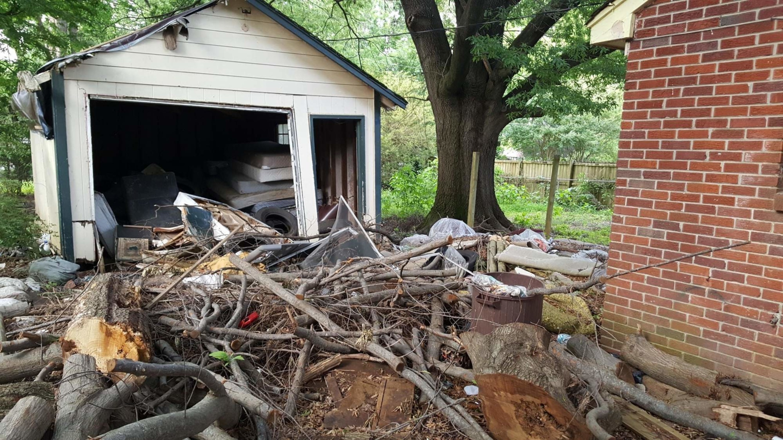 This photo was taken in April 2016 and shows a foreclosure in an African American neighborhood in Memphis, TN, with significant debris left in the yard by Bank of America.  This property is a health and safety hazard for people living nearby.