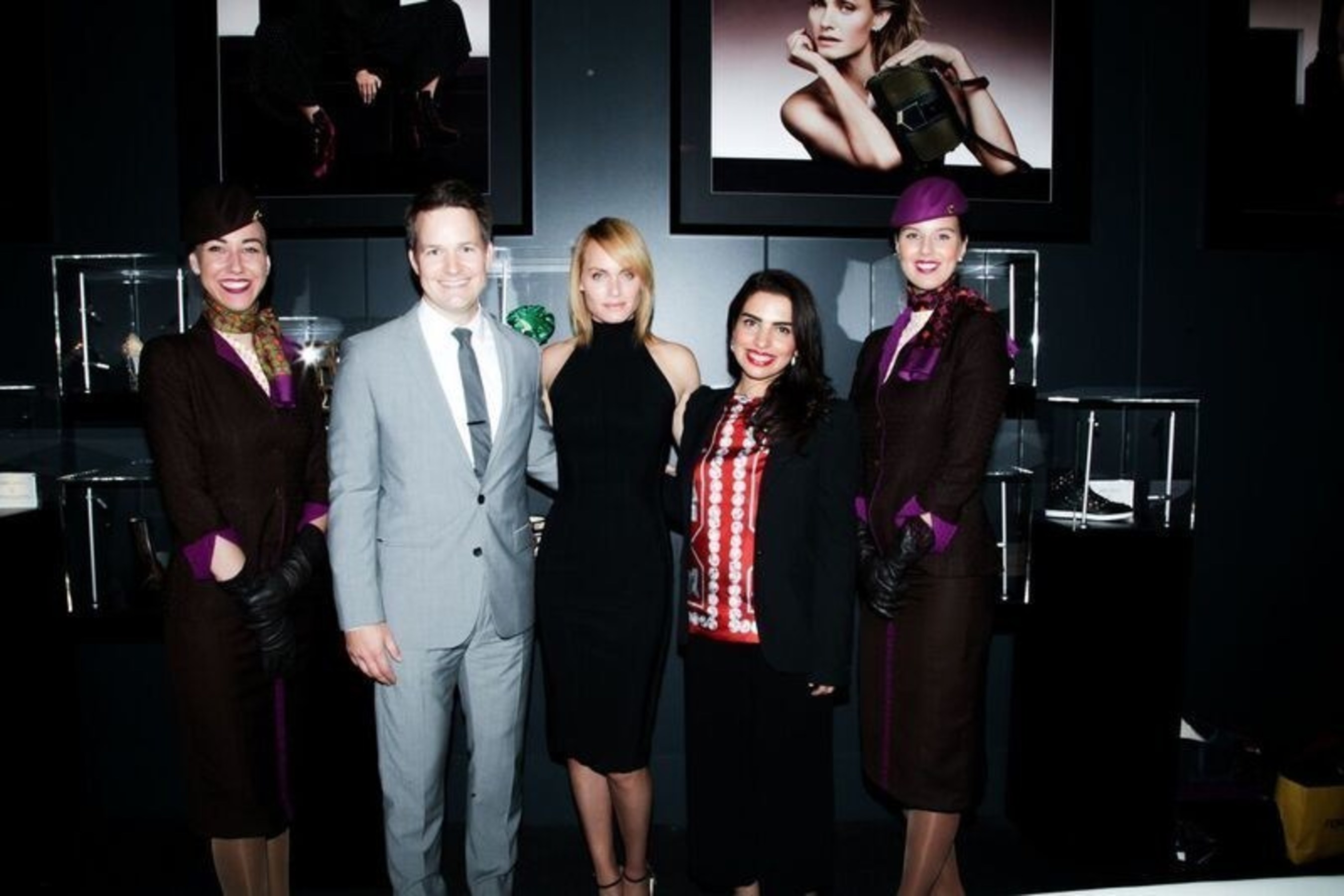 (From left to right, flanked by Etihad Airways cabin crew), Patrick Pierce, Vice President of Sponsorships - Etihad Airways; Supermodel Amber Valletta; and Amina Taher, Head of Corporate Communications - Etihad Airways celebrate the opening of the Jimmy Choo VIP Lounge hosted by Etihad and WME | IMG at Skylight at Moynihan Station.
