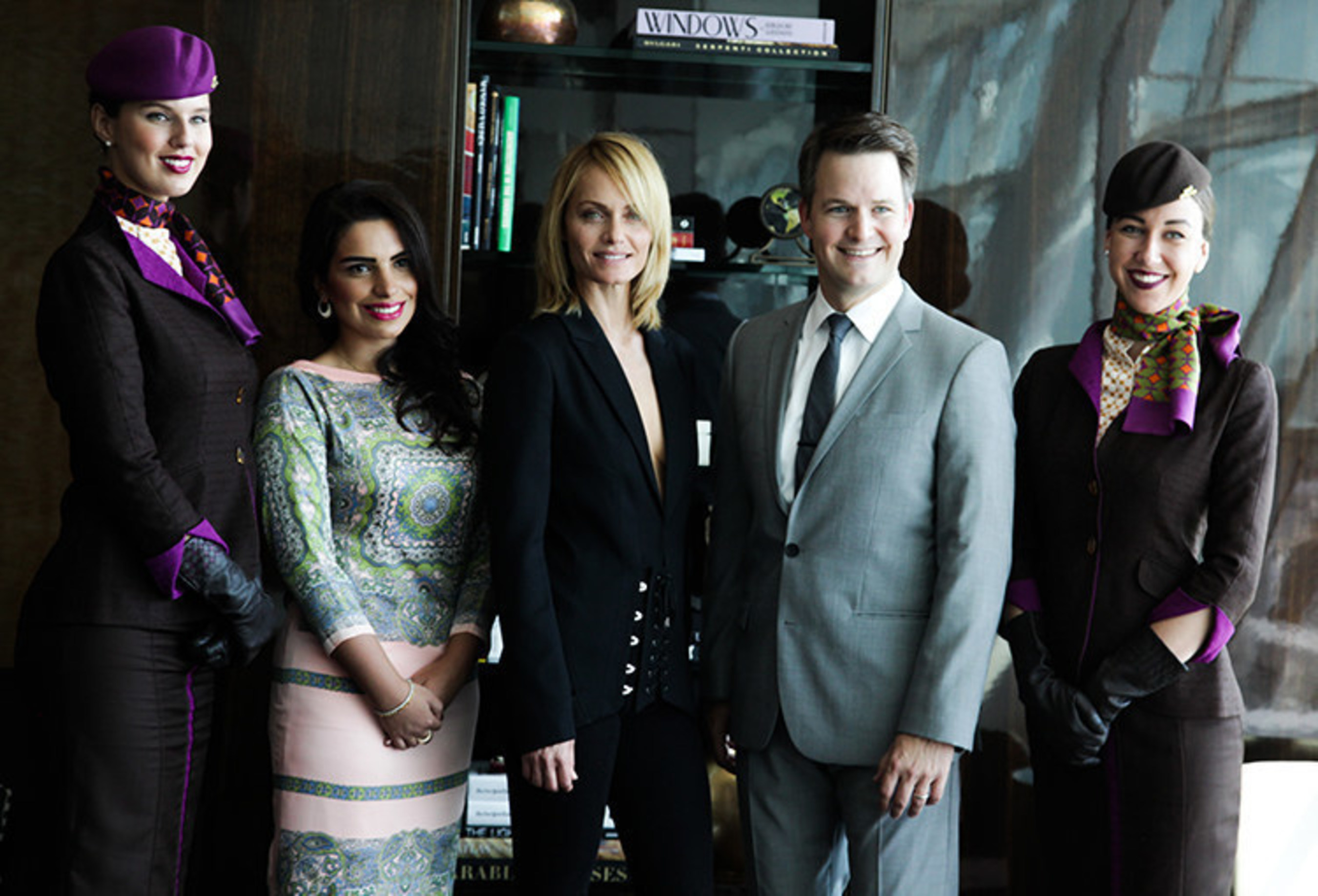(From left to right, flanked by Etihad Airways crew) Amina Taher, Head of Corporate Communications - Etihad Airways; Supermodel Amber Valletta; and Patrick Pierce, Vice President of Sponsorships - Etihad Airways; and Supermodel Amber Valletta celebrate the launch of the partnership between Etihad Airways and Jimmy Choo for New York Fashion Week at the Etihad Airways First & Business Class Lounge at JFK International Airport in New York City.