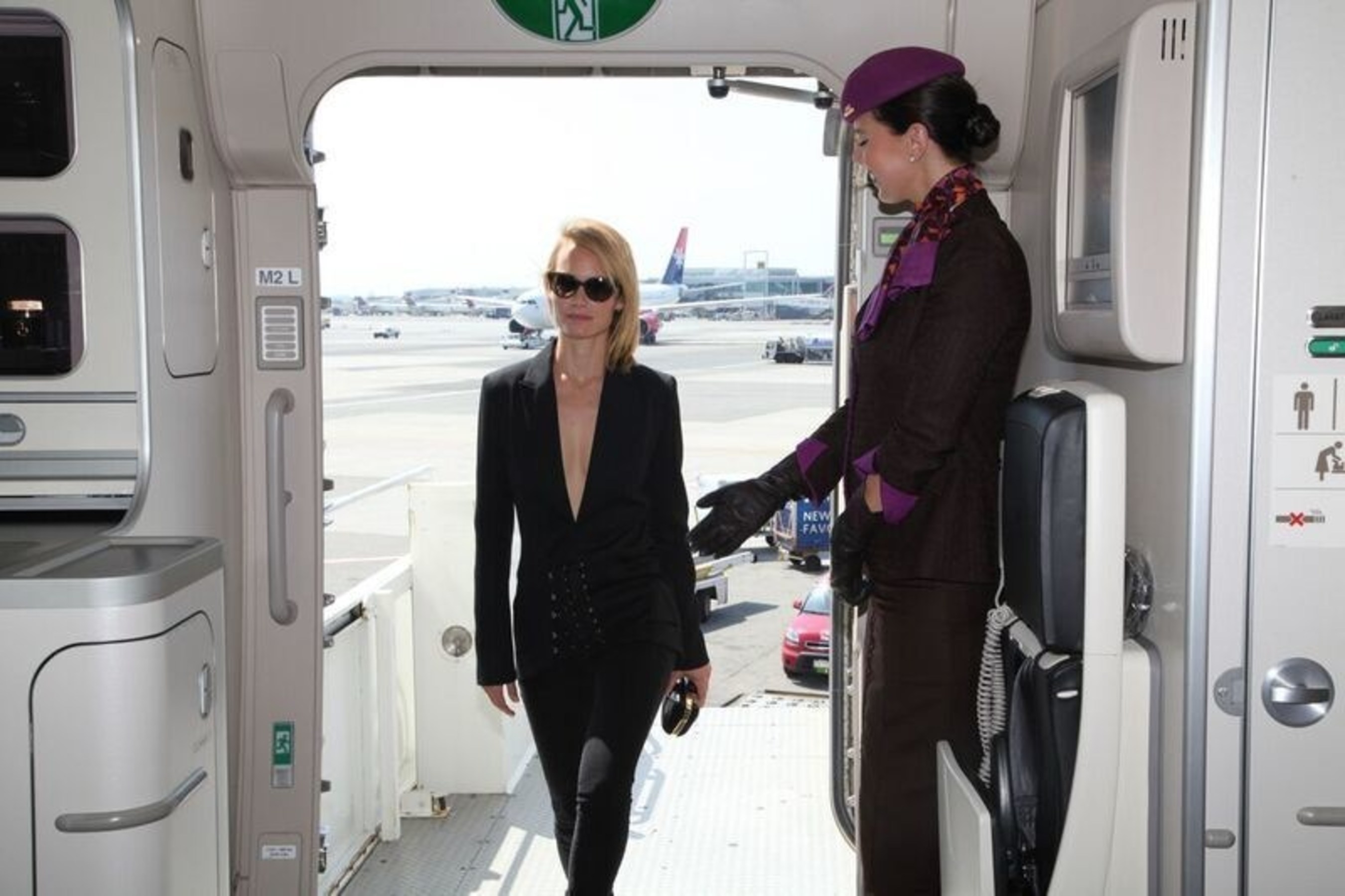 Supermodel Amber Valletta welcomed by Etihad Airways cabin onboard the airline's "NYFW: The Shows"-branded aircraft livery by cabin crew.