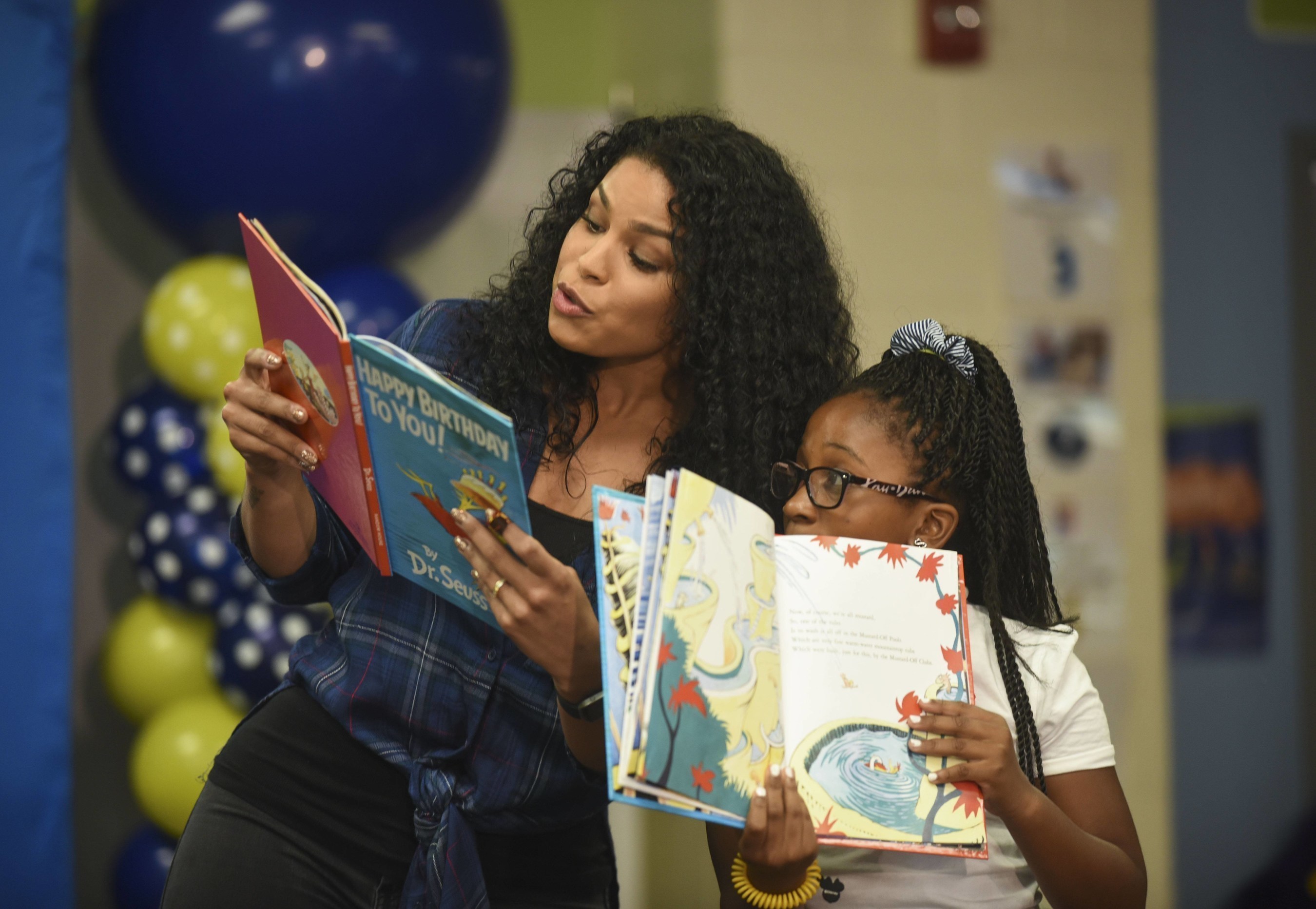 Singer and actress Jordin Sparks reads from Dr. Seuss' "Happy Birthday to You!" with a student from Amidon-Bowen Elementary School during Reading Is Fundamental's 50th Anniversary on Wednesday, Sept. 14, 2016, in Washington. (Kevin Wolf/AP Images for Reading Is Fundamental)