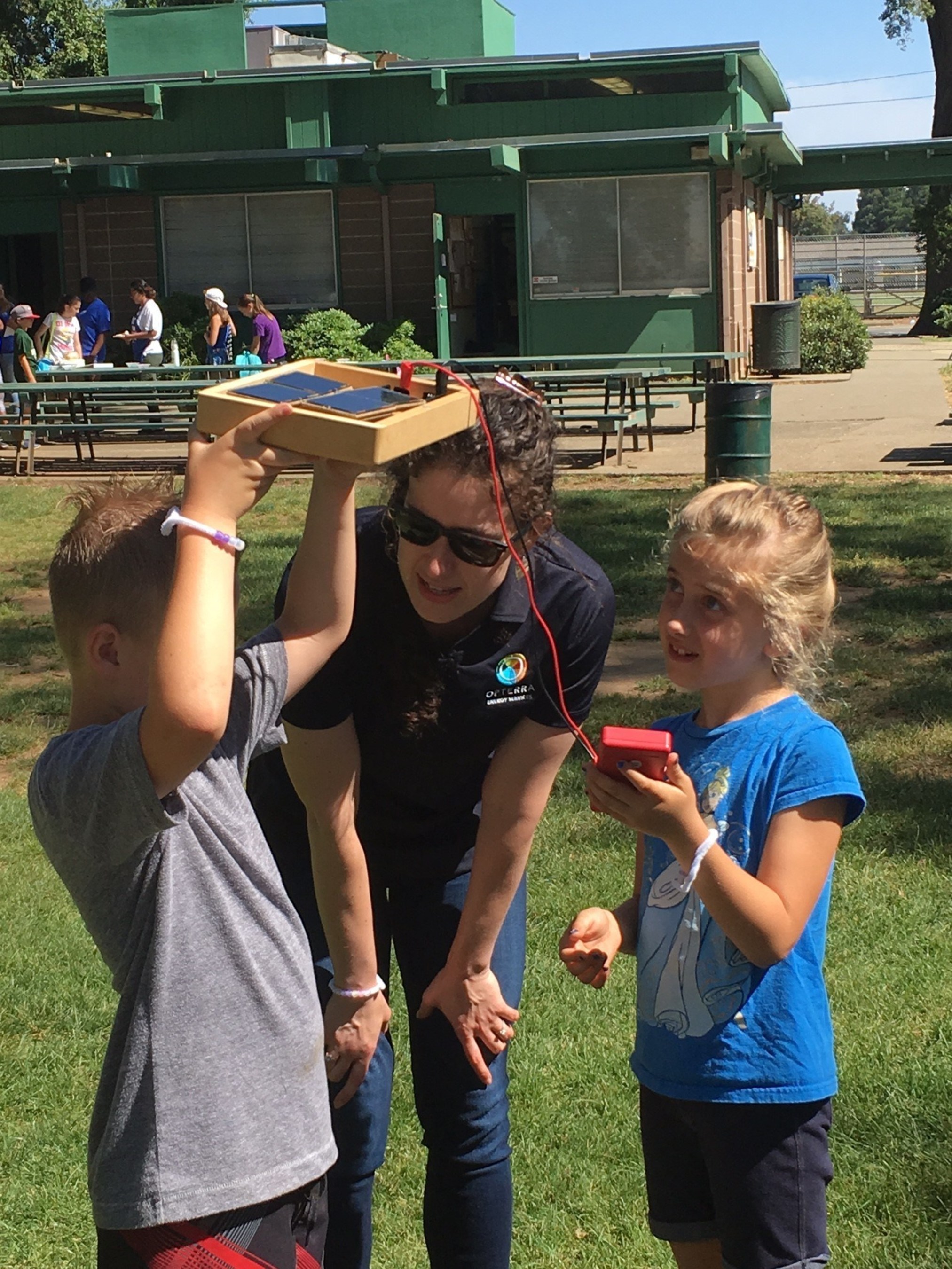 OpTerra Energy Services Education Team member teaches Cosumnes CSD residents about the science behind solar energy at this year's "Weird Science" camp.
