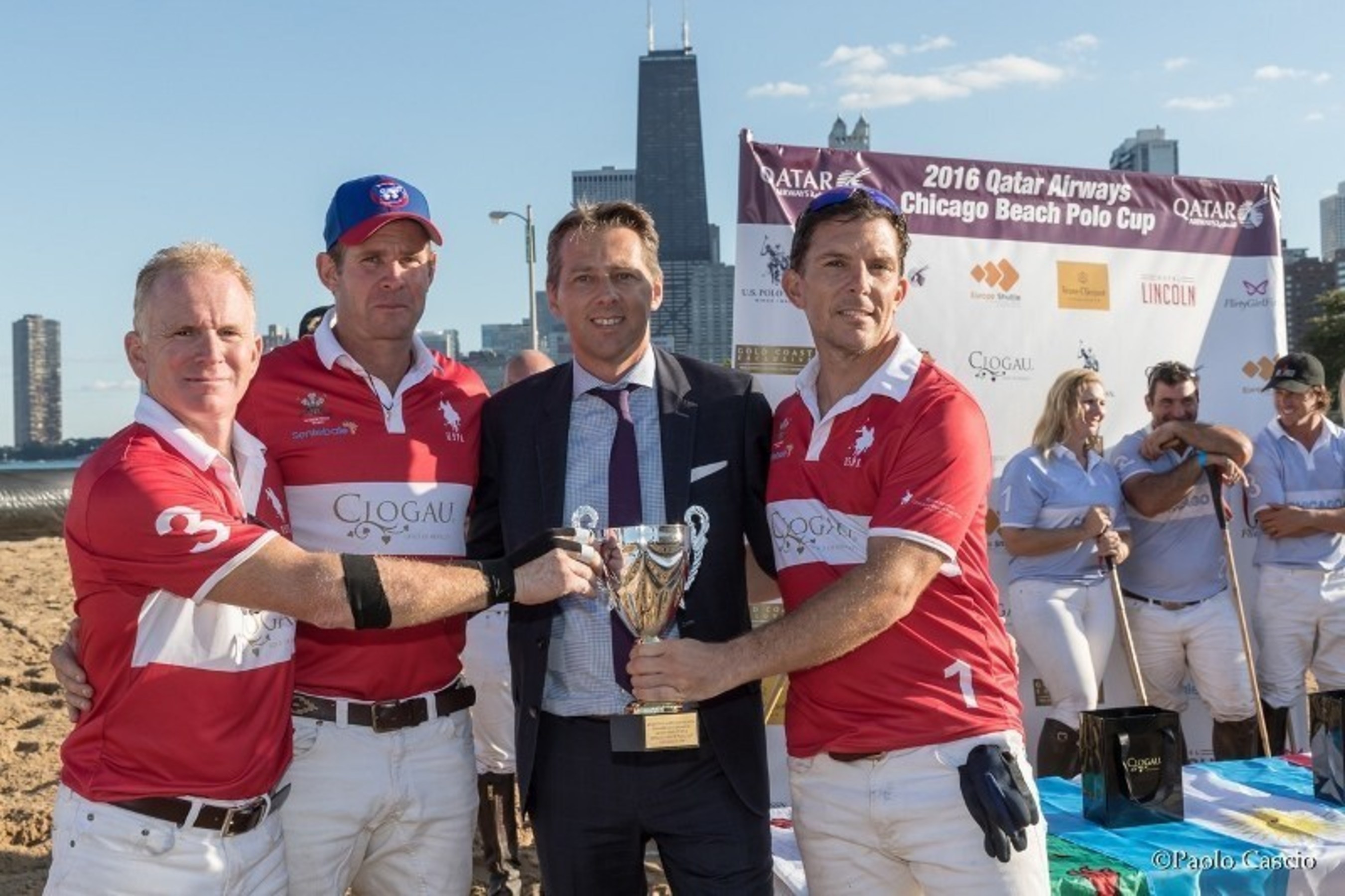 Mr. Gunter Saurwein, Qatar Airways' VP of Americas, congratulates the winners of the Chicago Beach Polo Cup, the Royal Wales Polo Team.