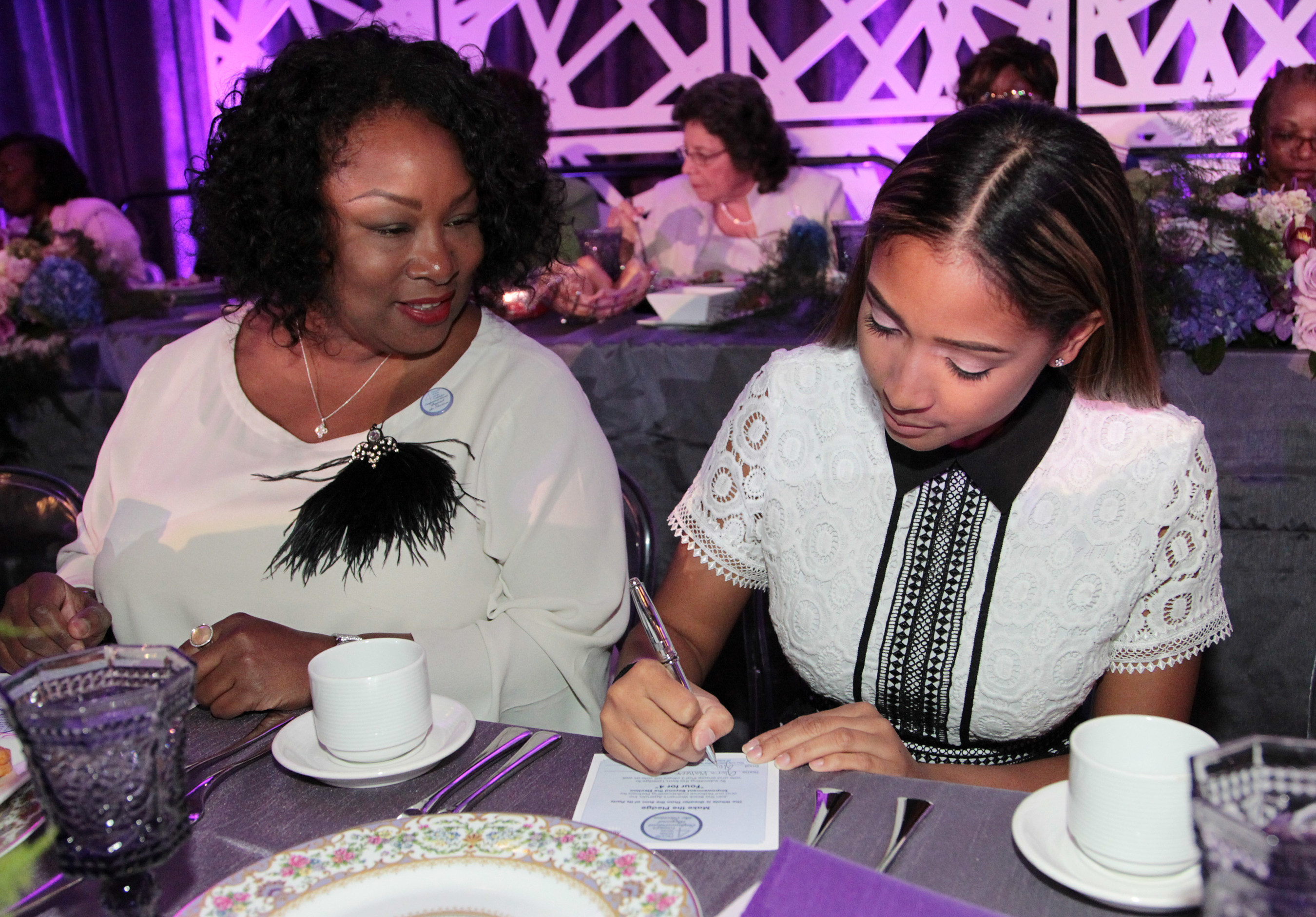 During The Black Women's Agenda, Inc. (BWA) 39th Annual Symposium Awards Luncheon, attendees were encouraged to participate in BWA's "Four For 4" get-out-the-vote initiative by signing pledge cards ensuring that at least four people, including themselves, vote in the November 2016 election. (Paul Morigi/AP Images for The Black Women's Agenda, Inc.)