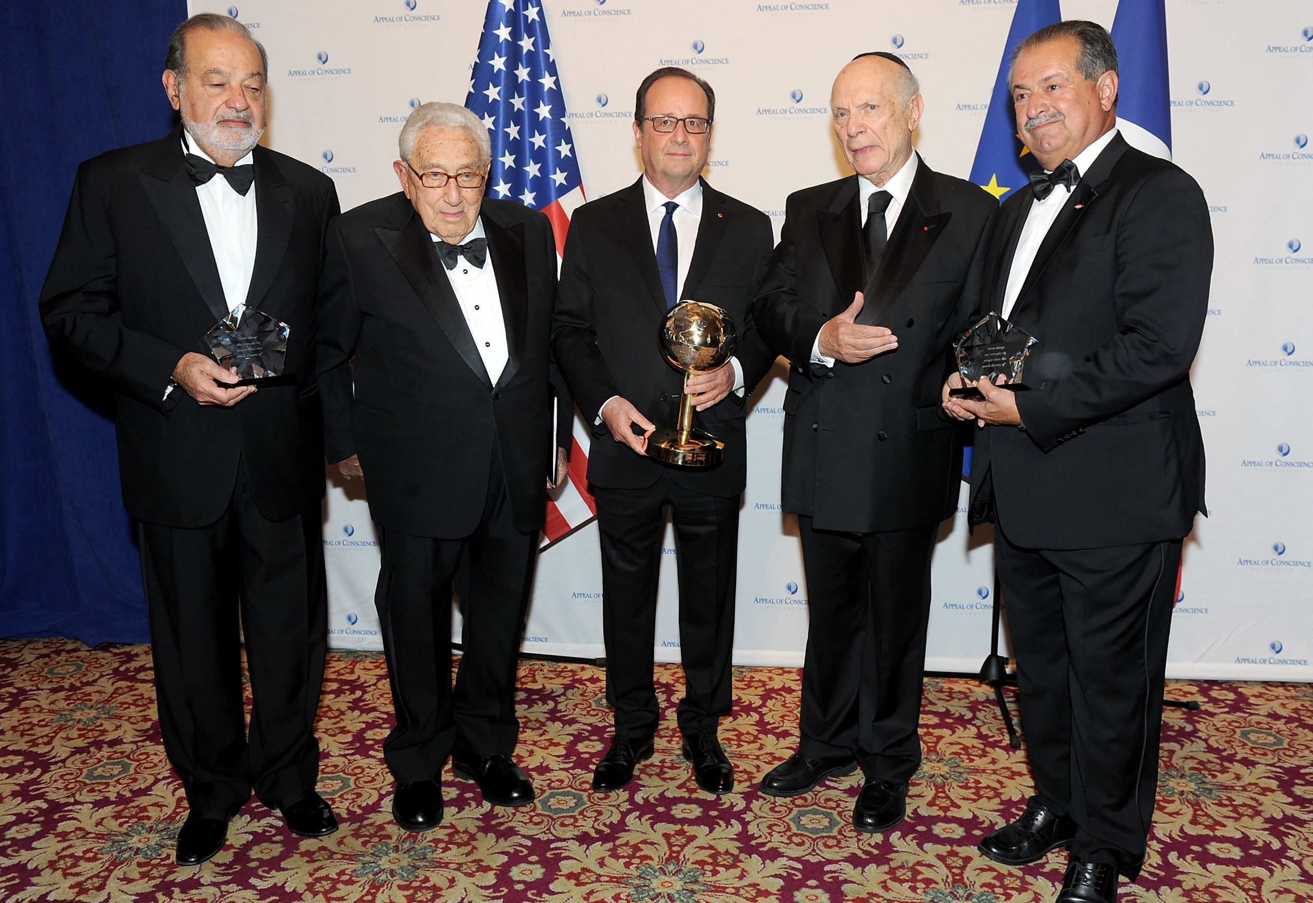 Rabbi Arthur Schneier, (2nd from right) the president and founder of the Appeal of Conscience Foundation and former United States Secretary of State, Dr. Henry Kissinger (2nd from left) present the 2016 World Statesman Award to French President, Francois Hollande (center). Mexican business magnate, investor, and philanthropist, Carlos Slim Helu (far left) and Andrew N. Liveris, the Chairman and Chief Executive Officer of The Dow Chemical Company (far right) received the 2016 Appeal of Conscience Awards at the 51st Annual Appeal of Conscience Awards Dinner held at the Waldorf Astoria in New York.
