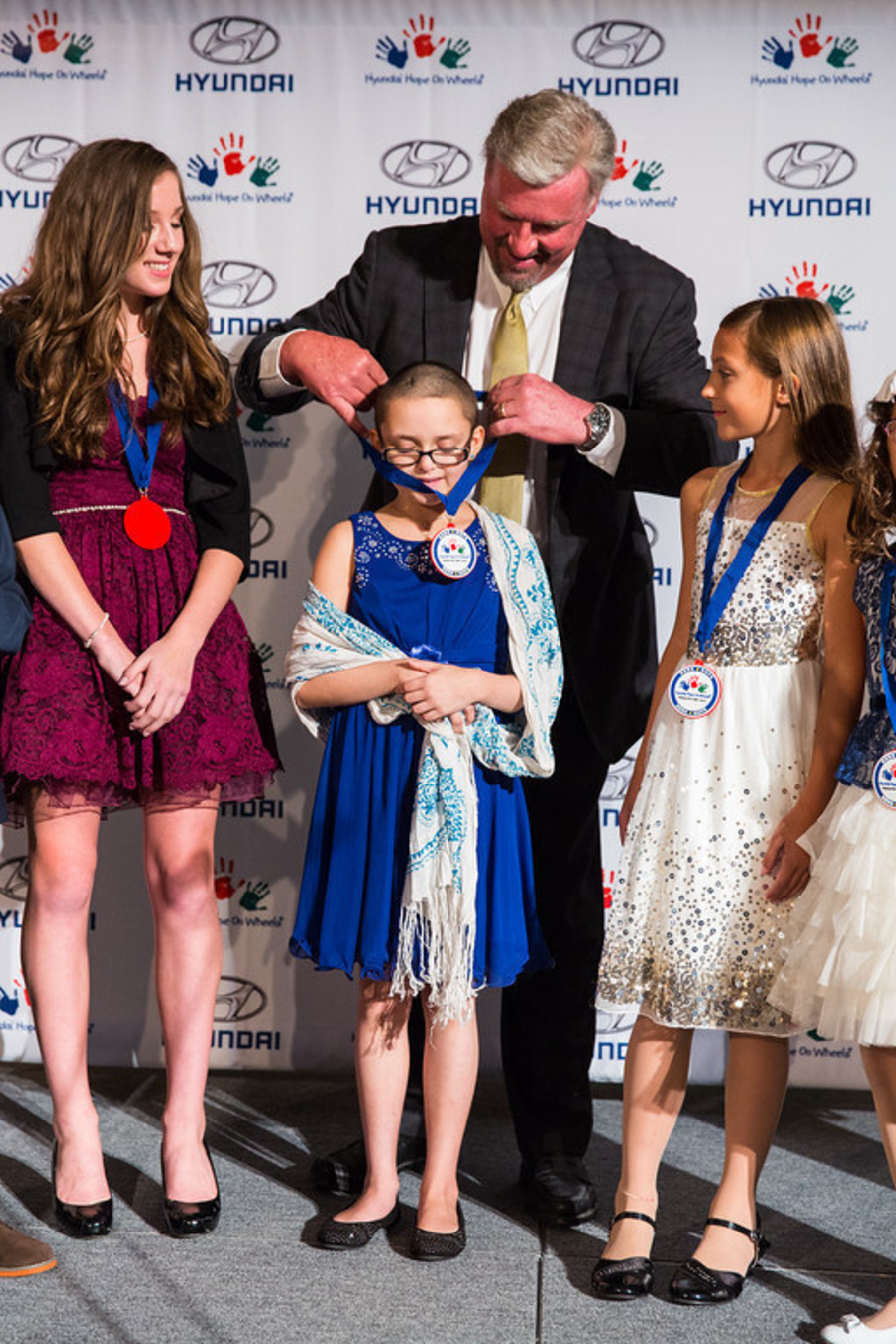 A Pediatric Cancer Fighter Receives a Medal of Recognition from Hyundai Motor America President and CEO Dave Zuchowski