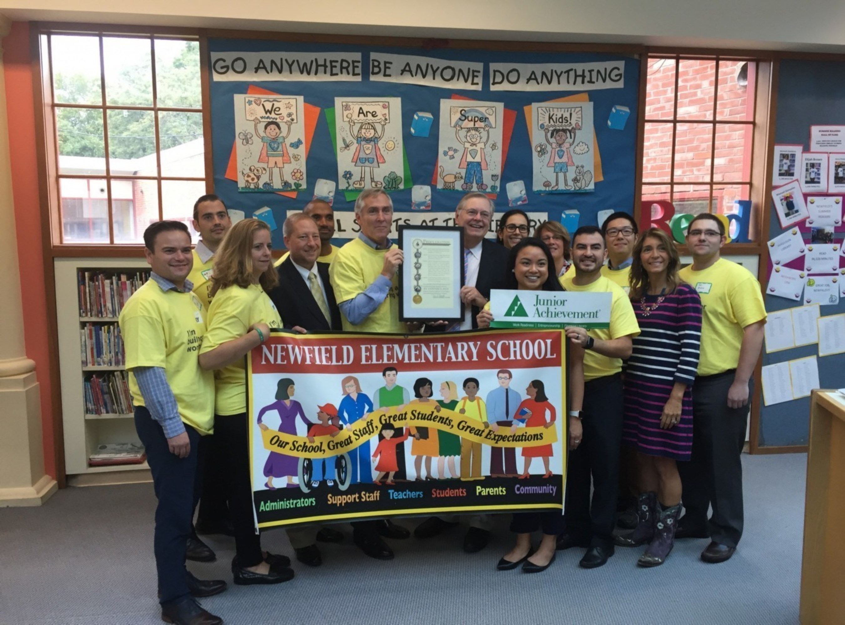 Stamford Mayor David Martin hand delivers Mayoral Proclamation to Stamford Office Managing Partner  Bud McDonald and EY Team volunteering for Junior Achievement