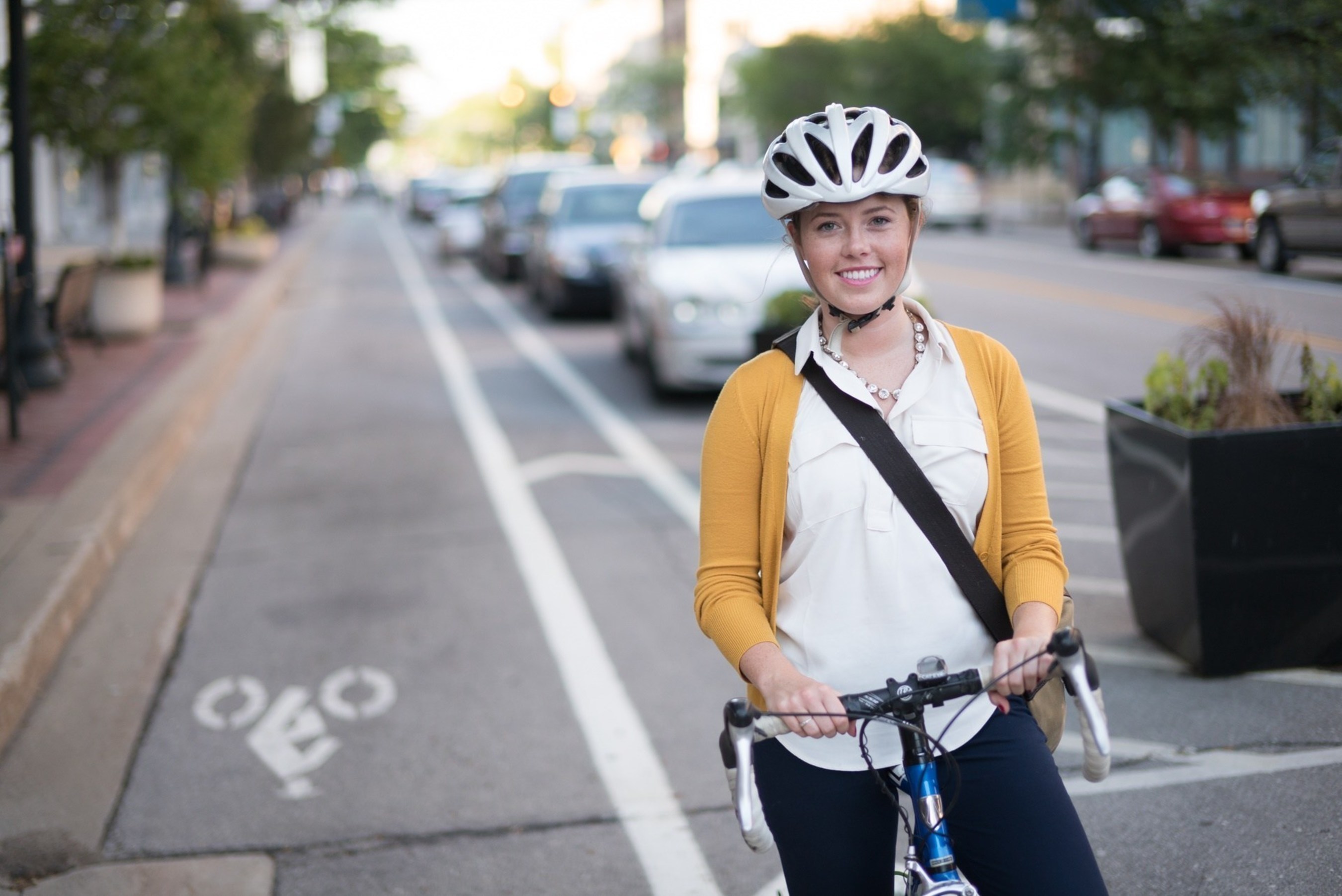 Katie Ramsey commutes along 3rd Street in Cedar Rapids, Iowa. With support from Blue Zones Project, Cedar Rapids introduced one of Iowa's first protected bike lanes in 2015.