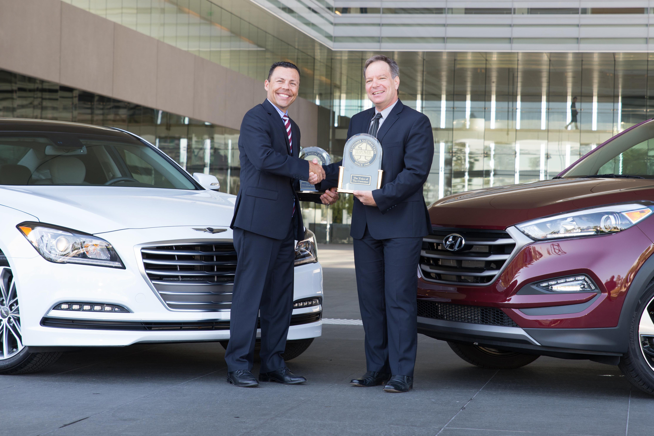 Mircea Gradu, director, engineering & quality, Hyundai Motor America accepts 2016 U.S. Tech Experience Index trophies for the Hyundai Tucson and Hyundai Genesis from Mike Battaglia, vice president, Automotive Retail Global Automotive Practice, J.D. Power.