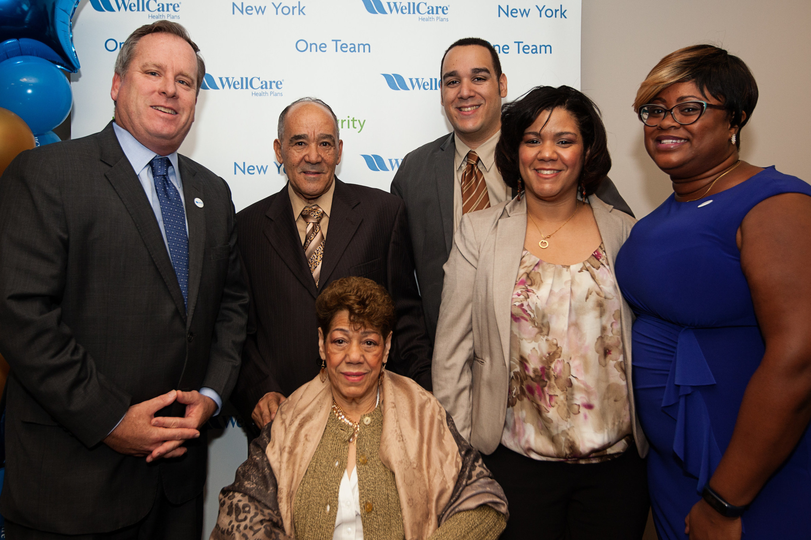 Maria Marte, pictured in the wheelchair above, is surrounded by her family and WellCare of New York President John J. Burke (far left) and WellCare of New York care manager Trisha Simon (far right). Mrs. Marte is a WellCare of New York member who was assisted by the company's field-based care management program, which is designed to provide personalized care to high-risk members to help them improve and maintain their health.