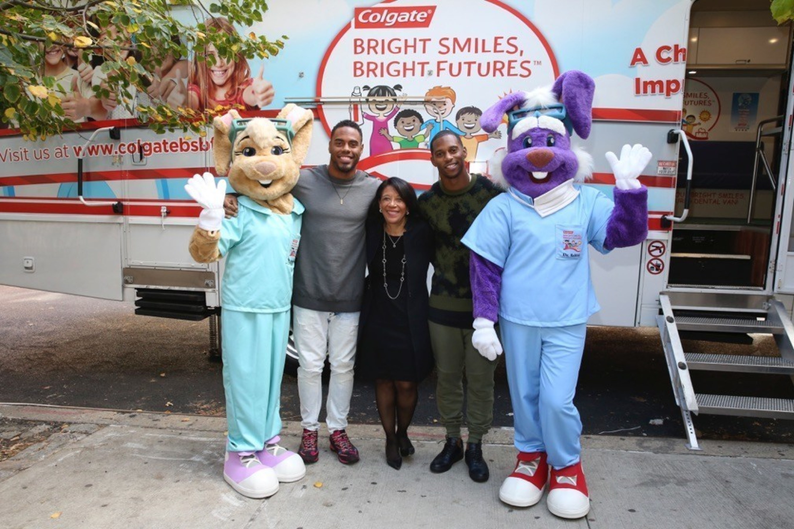 New York Giants  Rashad Jennings (2nd left) and Victor Cruz (2nd right) join Dr. Marsha Butler (center), Vice President, Global Oral Health, Colgate-Palmolive Company, and Colgate mascots, Dr. Brushwell and Dr. Rabbit, in front of a Bright Smiles, Bright Futures (BSBF) mobile dental van during BSBF's 25th Anniversary celebration in New York City. (Mark Von Holden/AP Images for Colgate Bright Smiles, Bright Futures)
