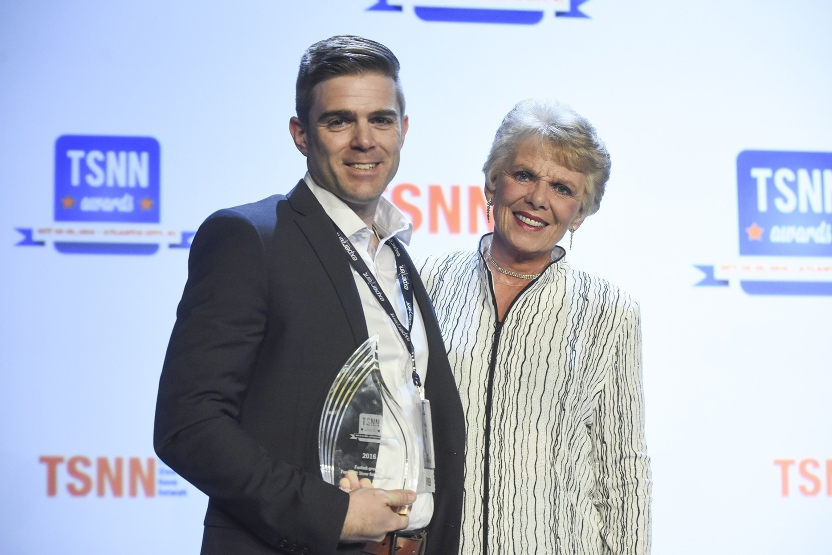 Jared Auld accepting the 2016 TSNN Award for OVERALL Fastest-growing For-profit Show in Attendance with presenter, Sue Trizila, CEO of Wyndham Jade.  Photo credit: (c) The Photo Group 2016