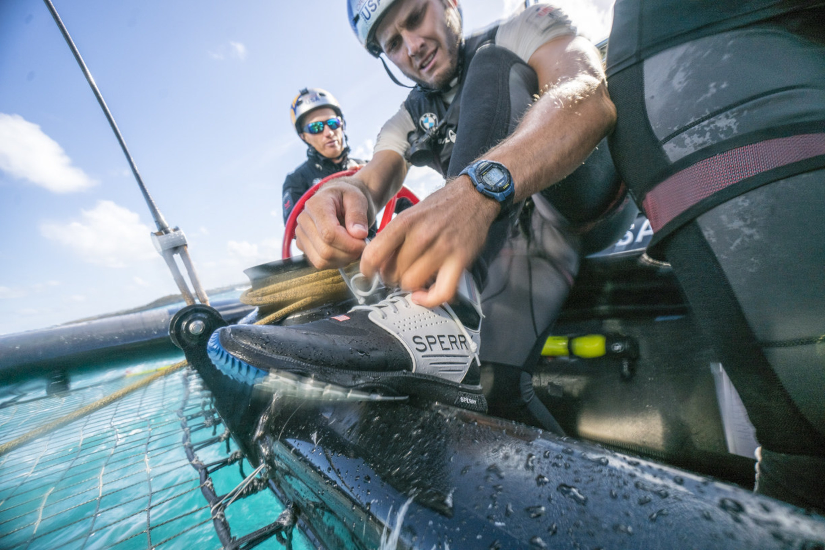 ORACLE TEAM USA athlete TJ Johnson laces up the new Sperry 7 SEAS Pro shoe before racing Photo Credit: Sam Greenfield