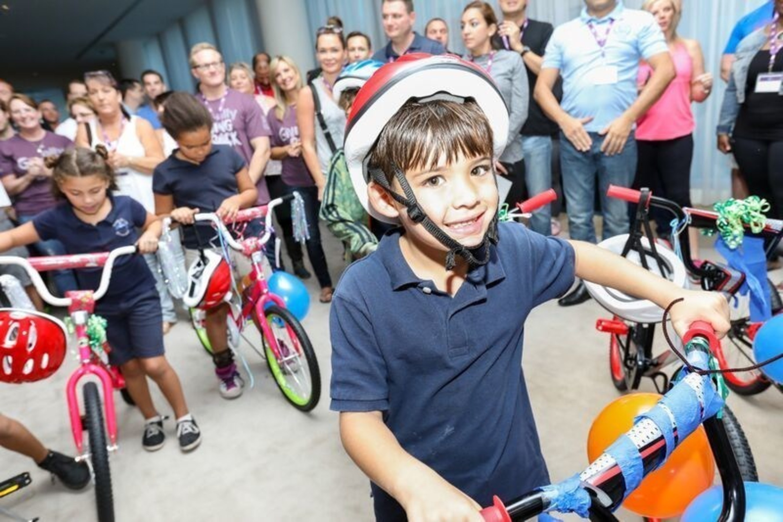 Boys and Girls Club of South Beach children are surprised with their new bikes for the holidays.