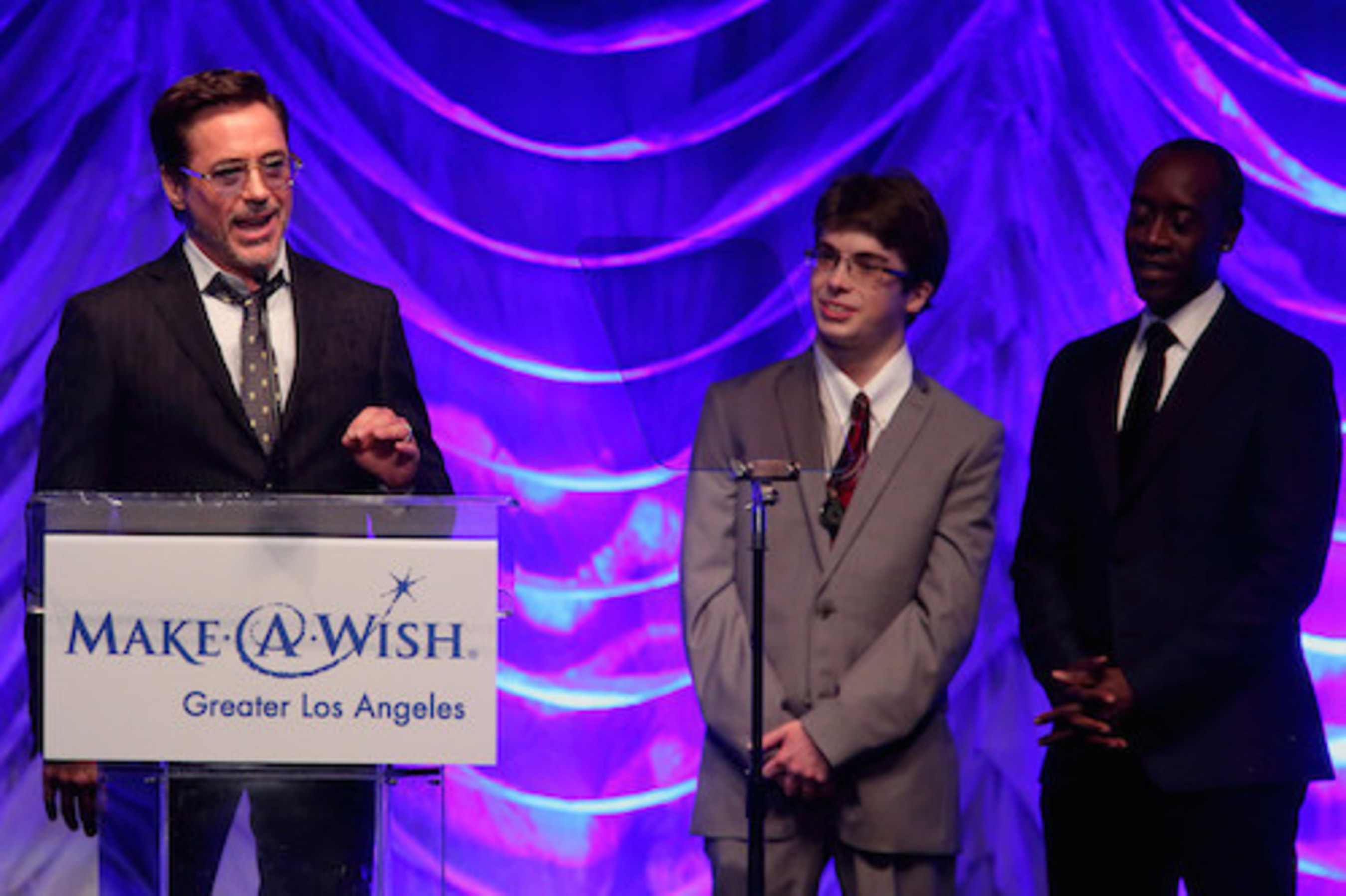 Oscar(R)-nominated actor Don Cheadle and Wish Kid Cameron Fisch (now age 22) presented Robert Downey Jr. with the Shining Star Award for the dozens of wishes that he has granted to children around the world. Downey fulfilled Cameron's wish five years ago when he invited the then 17-year-old, who has a nervous system disorder, to the movie set of The Avengers. Photo Credit: Craig T. Mathew and Greg Grudt/Mathew Imaging