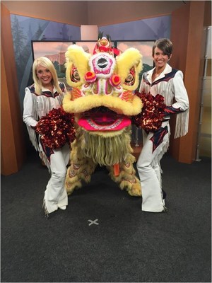 Denver Broncos Cheerleaders Faymie and Sam with a traditional Chinese lion dance promoting the upcoming Cathay Pacific Chinese New Year festivities in Hong Kong during a media tour in Denver, Colo. Photo credit: Shawna Peters.