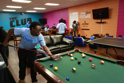 London Watkins, 17, shoots pool on a new table as Aaron's employees and members of the Eastside Boys and Girls Clubs of San Antonio unveil the newly remodeled Keystone Club (Teen Center), in San Antonio, Monday, February 16, 2015. (J. Michael Short/AP Images for Boys & Girls Club of America)