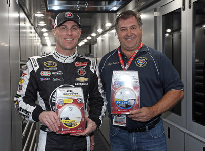 NASCAR Sprint Cup champion Kevin Harvick presents a donation of 250 smoke alarms to Rick Butcher, President, Florida Fire Marshals and Inspectors Association at the Daytona International Speedway on February 13.