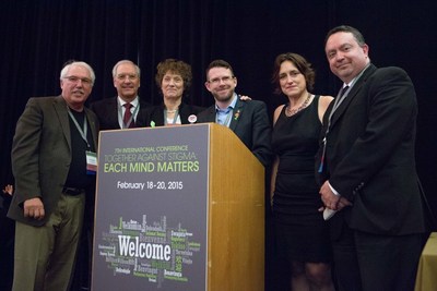 Mental health thought leaders from around the world assembled at the 7th International Together Against Stigma Conference. Panelists (from left) Wayne Clark, Michael Pietrus, Johanne Bratbo, Andrew Thorp, Sue Baker, and Paolo del Vecchio, gather around the podium at the 7th annual International Together Against Stigma Conference, on Friday, February 20, 2015 in San Francisco, CA. Over 750 attendees from all over the world converged at the three-day gathering, participating in workshops and discussions surrounding mental health. (Don Feria/AP Images for Each Mind Matters)