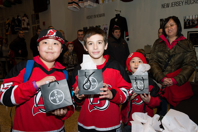 Young Devils fans receive souvenirs at Bayer Fights Cancer Night on Feb. 6, 2015.