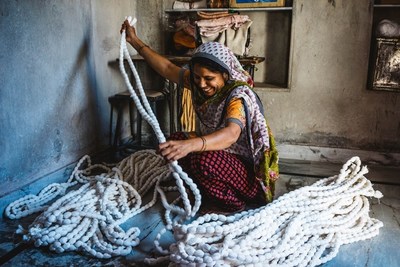 A woman tie-dies fabric in Jodhpur, India.