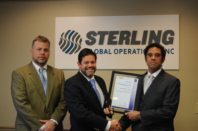 Jeremy Duncan, Sterling Global Operations (SGO) vice president of operations, and Alan Weakley, SGO president and chief operating officer, receive from Tony Phipps, director of United Kingdom-based MSS Global, SGO's designation as the first American company to receive worldwide certification under ANSI/ASIS PSC.1-2012, an international standard designed specifically for private security company quality management systems.