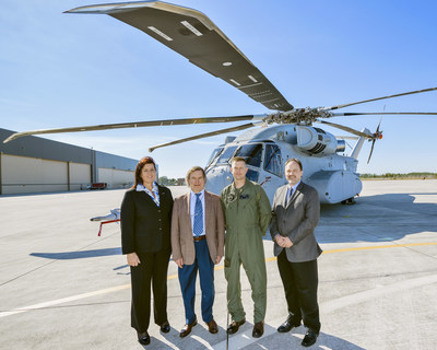 Representatives from Sikorsky, NATO JCGVL and the USMC stand in front of the CH-53K helicopter at Sikorsky's Florida Assembly Flight Operations Center (FAFO) in West Palm Beach, Florida. (Pictured from left to right) Caroline Vandedrinck (VP Europe & Central Asia, Sikorsky Aircraft), Hans-Peter Mueller (NATO JCGVL Committee Chairman), Lt. Col. John Ennis (CH-53K Government Flight Test Director), Mike Torok (VP CH-53K Program, Sikorsky Aircraft).