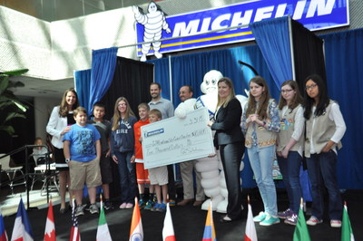 Michelin North America presents a check for $10,000 to Ellen Woodside Elementary and artist, Patricia Thomas, winners of the InTireNational Art contest held in Upstate, South Carolina.