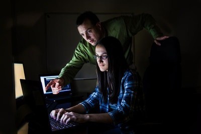Paul Krier trains Southern Methodist University student Alyssa Rahman for the National Collegiate Cyber Defense Competition. Krier, a Raytheon cybersecurity expert, is one of five 