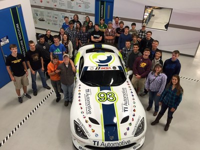Students from Bullock Creek High School pose with the TI Automotive No. 93 Dodge Viper SRT display car at the TI Automotive Technical Center in Auburn Hills, Mich. on May 13, 2015.