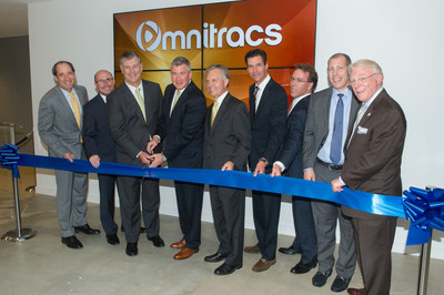 Omnitracs' CEO John Graham, its executive team and Dallas Mayor Mike Rawlings cut the ribbon to officially welcome the company to downtown Dallas