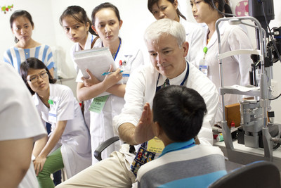 Dr. Douglas Fredrick from the Stanford School of Medicine works through the stages of a diagnosis with hands-on trainees at the Hue Central Hospital during the second week of the Flying Eye Hospital program in Hue. Learn more: orbis.org (photo: Geoff Bugbee/Orbis).