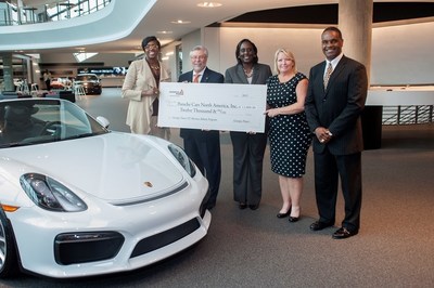 Left to right, Latanza Adjei, vice president of sales for Georgia Power and Tim Quinn, vice president of AfterSales for Porsche Cars North America, are joined by Lisa Smith, Glenda Draper and Carl Jackson from Georgia Power at Porsche Cars North America, Inc. for workplace charging rebate presentation.