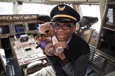 2015 March for Babies National Ambassador Elijah Jackson in airplane cockpit, earing captain's hat, holding the teddy bear named in his honor and Ben Flyin teddy bear.