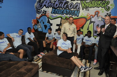 James DeLaurentis, center, a General Manager at an Aaron's Niagara Falls store, Senator Tim Kennedy (D-NY), and Dave Edwards, far right, President & COO of SEI, Inc., Aaron's largest franchisee, unveil the Keystone Club makeover to enthusiastic teens at the John F. Beecher Clubhouse last Friday. Aaron's employees added new furniture, electronics and paint for Keystone teens to have their own space to study and lounge. The Boys & Girls Clubs of America Keystone program enables teens to build critical...