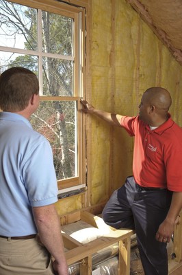 A Georgia Power representative discusses ways to save money and energy with a customer during an in-home energy audit. In-home energy audits are just one of the money-saving services available to customers as high temperatures increase use this week.